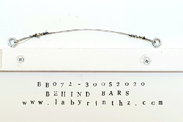Behind bars - signed on the back